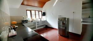 a large kitchen with a stainless steel refrigerator at Ashleys Homestay in Cochin