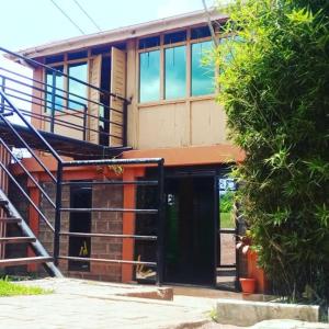 a building with a staircase in front of it at WAYPOINT SUITES HOTEL in Kabale