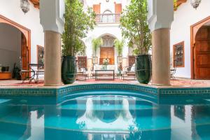 an indoor pool in a house with plants at Riad Les Trois Palmiers El Bacha in Marrakesh
