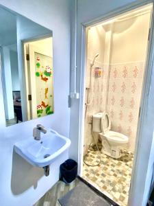 a bathroom with a sink and a toilet at The Alex in Ban Don Muang