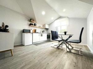 a kitchen with a table and chairs in a room at Pena Apartments C in Funchal