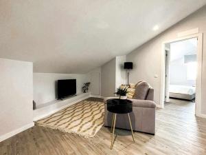 a living room with a couch and a television at Pena Apartments C in Funchal