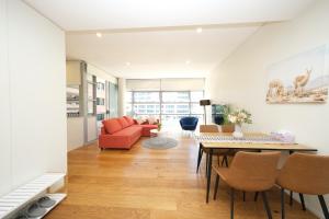 a living room with a couch and a table at Alora Apartment in Sydney CBD - Darling Harbour in Sydney