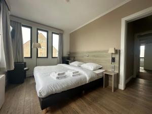 Arriate Hotel في لوتشريستي: غرفة نوم بسرير كبير مع شراشف بيضاء