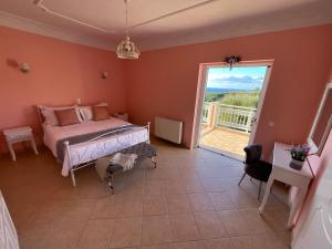 a bedroom with a bed and a large window at Villa Kaminia Rose private pool & Jacuzzi in Ratzaklíon +32 photos