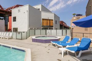 a patio with chairs and a swimming pool and an umbrella at Old Town 1br near dining bars tech hubs PDX-15 in Portland