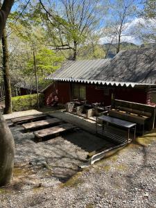 a group of benches in front of a red building at Jomine Koen Campjo - Vacation STAY 85267v in Minano