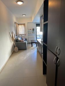a kitchen and living room with a couch at DRYADES in Agios Nikolaos +6 photos