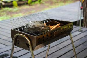 a grill on a deck with a bunch of food in it at Work Shop Camp Resort Forest and Lake Paradise - Vacation STAY 85274v in Fujikawaguchiko