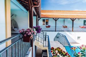a balcony with potted plants and flowers at Estalagem Bela Vista in Mondim de Basto