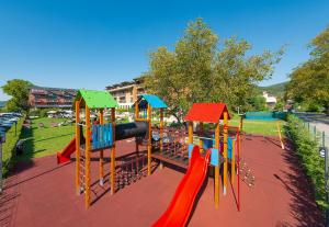 a playground in a park with a slide at Hotel Visegrád in Visegrád