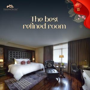 a hotel room with a bed and a reclined room at Paradise Suites Hotel in Ha Long