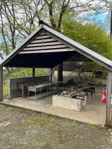 a picnic shelter with benches and a picnic table at Jomine Koen Campjo - Vacation STAY 85265v in Minano