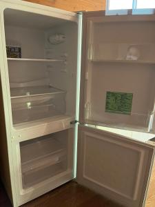 an empty refrigerator with its door open in a kitchen at Jomine Koen Campjo - Vacation STAY 85265v in Minano