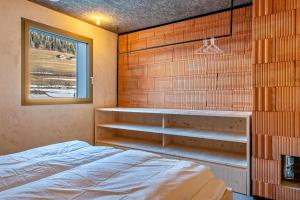 a bedroom with a bed and a window at Lena Dolomites Gartensuite in Villnoss