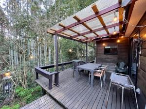 a wooden deck with a table and chairs at NAKADAKI ART VILLAGE - Vacation STAY 23991v in Shiigi