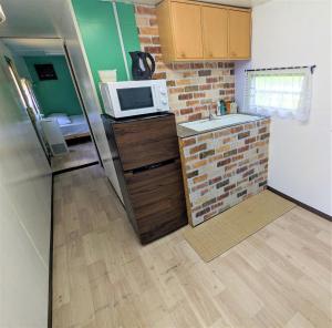 a kitchen with a refrigerator and a microwave at BULLs Camp - Vacation STAY 56022v in Narusawa
