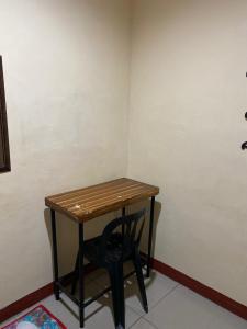 a small table and a chair in a room at Jow's Place in Tarlac