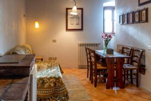 a living room with a table and a couch at La Taberna di Rocca Calascio in Calascio