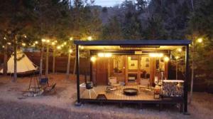 a small cabin with a deck at night at Re Come Across Doglamping - Vacation STAY 42085v 