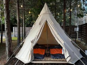 a white teepee tent sitting in a yard at Re Come Across Doglamping - Vacation STAY 42085v 