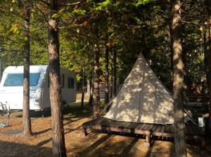 a tent and a bench in the woods with a trailer at Re Come Across Doglamping - Vacation STAY 42085v 