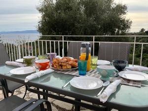a table with a plate of food on top of it at Villa Kaminia Rose private pool & Jacuzzi in Ratzaklíon