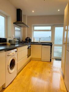 a kitchen with a sink and a dishwasher at House in Ebbw Vale in Ebbw Vale