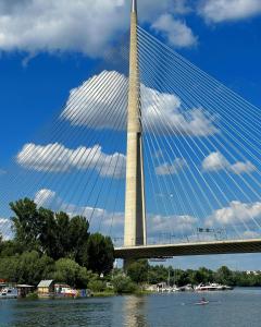 a bridge over the water with a sky at Splav Cilim House in Belgrade