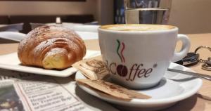 a cup of coffee and a pastry on a table at Casa Vacanze Mandriavecchia in Petrosino