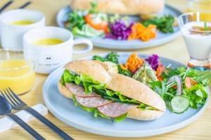 two plates of food with a sandwich and a salad at La-gum - Vacation STAY 42370v in Inatori
