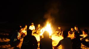 a group of people sitting around a bonfire at Grand Beach - Vacation STAY 23978v in Iki