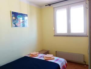 a bedroom with a bed and a window at Rise and shine! in Pula