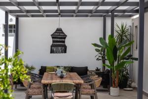 a living room with a table and a couch at Kournas Nature's Nest in Kournás