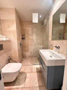 a bathroom with a sink and a toilet and a shower at Spacious Central London flat - 2BHK in London