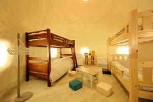 a bedroom with two bunk beds and a desk at ASOGUNI Glamping - Vacation STAY 22084v in Oguni