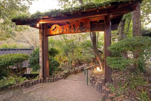 a wooden gate in a garden with a path at ASOGUNI Glamping - Vacation STAY 42307v in Oguni
