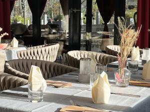 a table in a restaurant with tables and chairs at Grimm's Potsdamer Platz in Berlin