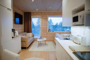 a small kitchen and living room in a tiny house at Villa Vaalea in Rovaniemi