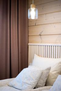 a bedroom with a bed and a brown curtain at Villa Vaalea in Rovaniemi