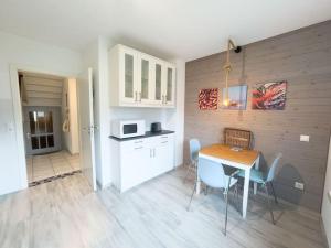 a kitchen and dining room with a table and chairs at Haus Glücksfang in Hooksiel in Wangerland