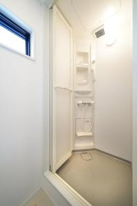 a white bathroom with a shower and a window at SENKO TINY CAMP - Vacation STAY 85298v in Ueda