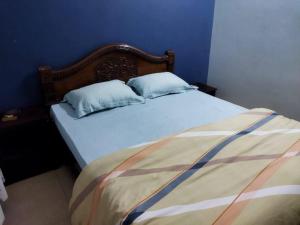 a blue bedroom with a bed with two pillows at 3BHK Luxury House near Calangute/Bagha(C4) in Anjuna