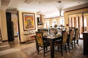 a dining room with a table and chairs at White River Country Estate - Self Catering - AMH Home in White River