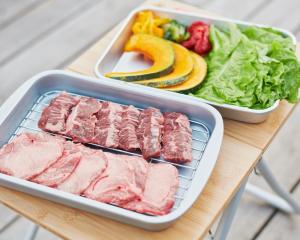 a table with a tray of meat and a salad at Kinoene SAKE CAMP - Camp - Vacation STAY 42049v 