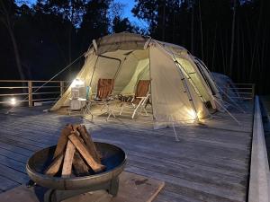 a tent on a deck with a pot of wood at Kinoene SAKE CAMP - Camp - Vacation STAY 42049v 