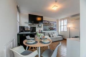 a kitchen and living room with a table and chairs at Spacious Duplex Apartment in the heart of Porto in Porto