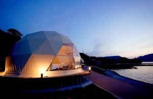ein großes Kuppelgebäude mit Lichtern im Wasser in der Unterkunft TADAYOI - Sea Glamping- Vacation STAY 42101v 