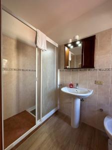 a bathroom with a sink and a shower at Mareblu B&B in Cefalù