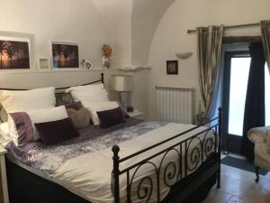 a bedroom with a large bed with pillows on it at La Stala in Pieve di Teco